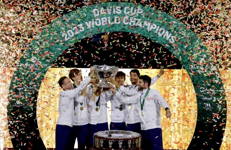 Italy's Lorenzo Musetti, Jannik Sinner, Matteo Arnaldi, Lorenzo Sonego, Simone Bolelli and captain Filippo Volandri celebrate with the Davis Cup trophy. -REUTERS PIC