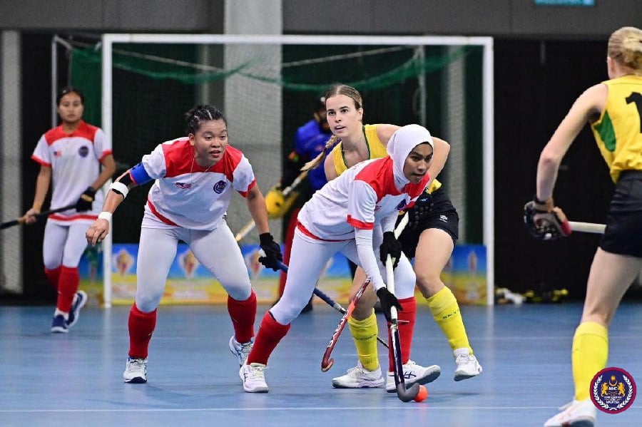 Malaysia (in white) against Australia in the Tuanku Zara International Indoor tournament. - Pic courtesy of MHC