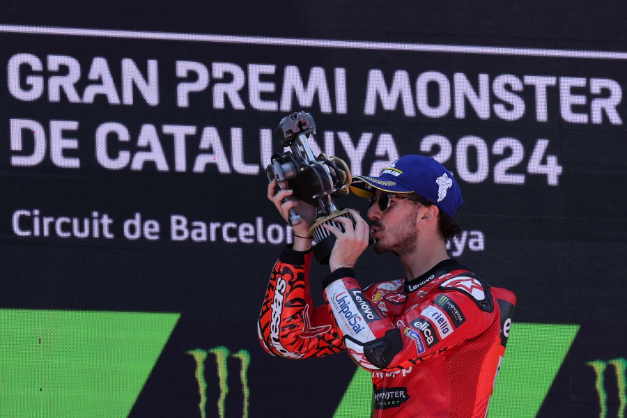  Ducati Italian rider Francesco Bagnaia celebrates on the podium after winning the MotoGP Race of the Moto Grand Prix of Catalonia at the Circuit de Catalunya on May 26, 2024 in Montmelo. - AFP PIC