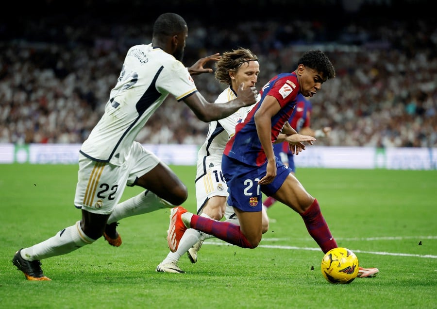 Barcelona's Lamine Yamal in action with Real Madrid's Antonio Rudiger and Luka Modric.- REUTERS PIC