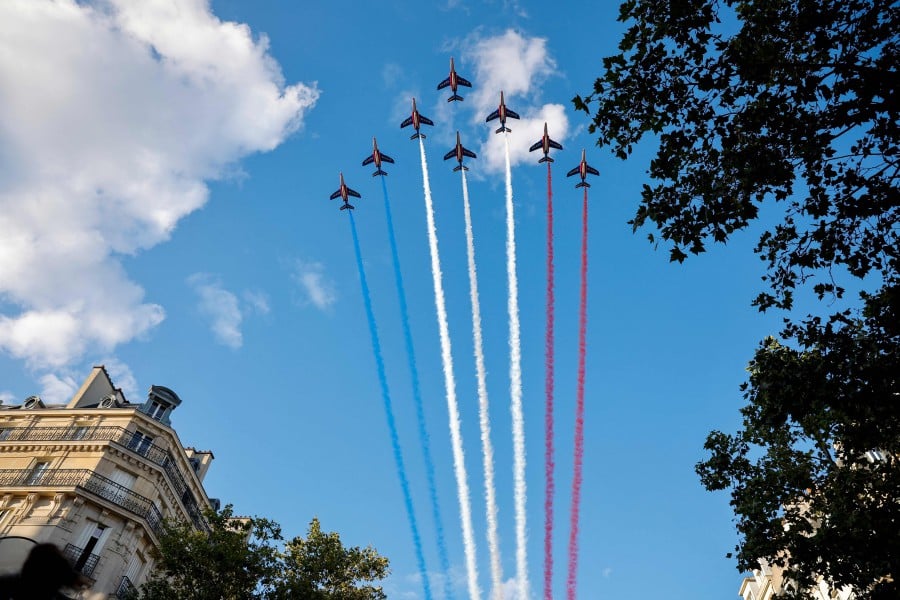 French Air Force elite acrobatic flying team "Patrouille de France" (PAF) perform a fly-over during a ceremony to mark the 80th anniversary of the liberation of Paris from the Germans in the World War II, in Paris on August 25, 2024. -- AFP