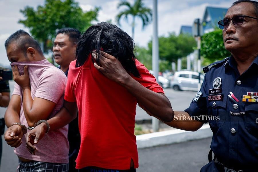  M. Gopala Krishnan (in red t-shirt) arrives at the Ayer Keroh Sessions Court ahead of the trial. - BERNAMA PIC