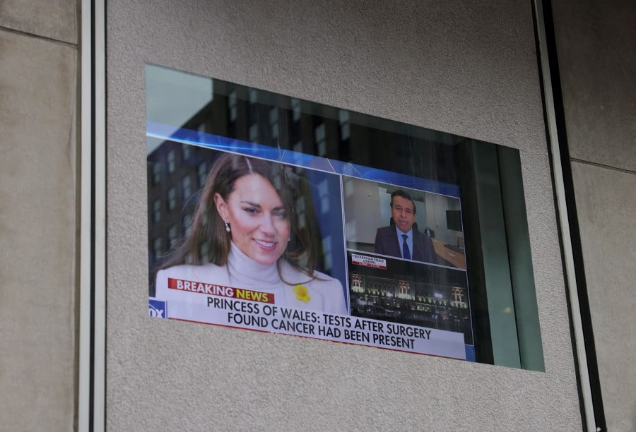 A screen shows the news on the health of Britain's Catherine, Princess of Wales, after she said she was undergoing preventive chemotherapy, since tests following her major abdominal surgery in January revealed that cancer had been present, outside the Fox News studio in the Manhattan borough of New York City. - REUTERS PIC