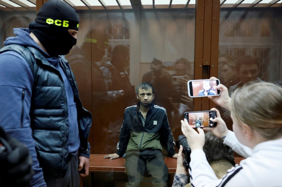 Shamsidin Fariduni, a suspect in the shooting attack at the Crocus City Hall concert venue, sits behind a glass wall of an enclosure for defendants before a court hearing at the Basmanny district court in Moscow. - REUTERS PIC