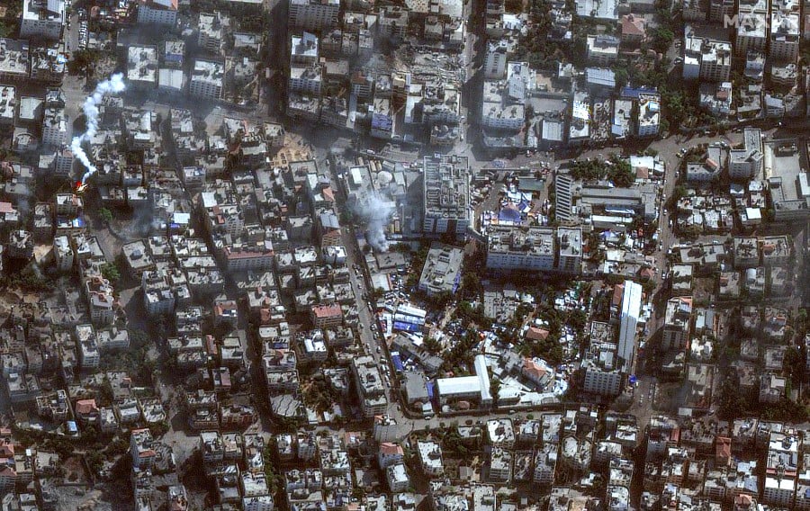This handout satellite picture released by Maxar Technologies shows the damage around the Shifa Hospital in Gaza City's al-Rimal district. - AFP PIC