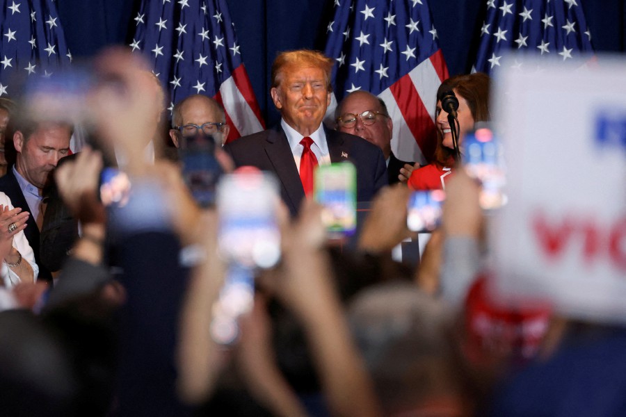 Republican presidential candidate and former U.S. President Donald Trump stands on stage as he hosts a South Carolina Republican presidential primary election night party in Columbia, South Carolina, U.S. (REUTERS/Shannon Stapleton)