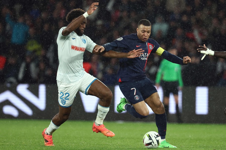 Le Havre's Yoann Salmier (L) vies with Paris Saint-Germain's Kylian Mbappe during the match at the Parc des Princes Stadium in Paris. - AFP PIC