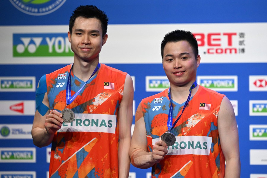 Aaron Chia and Soh Wooi Yik pose with their runners-up medals after the men's doubles final at the All England Open Badminton Championships at the Utilita Arena in Birmingham. - AFP PIC
