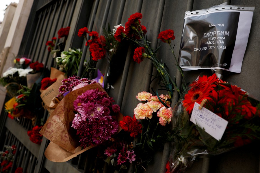 Tributes to the victims of a shooting attack at the Crocus City Hall concert venue in the Moscow Region, are placed outside the Russian Embassy in Madrid, Spain. - REUTERS PIC