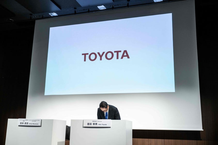 Toyota Motor Corporation Board Chairman Akio Toyoda bows during a press conference in Tokyo on June 3, 2024. - AFP 