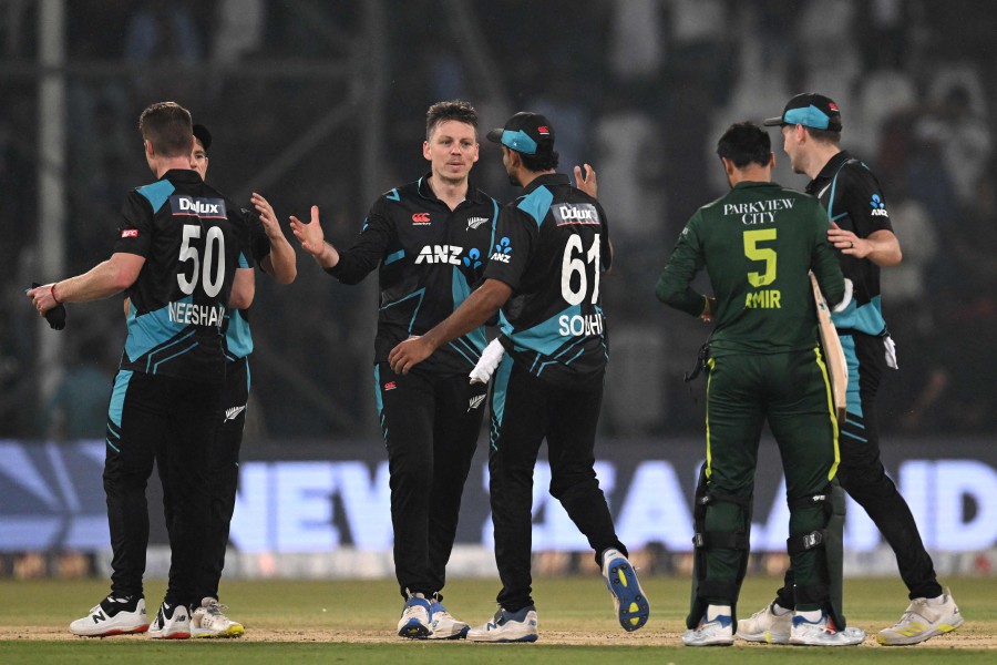 New Zealand's captain Michael Bracewell (CL) celebrates with teammates at the end of the fourth Twenty20 international cricket match between Pakistan and New Zealand at the Gaddafi Cricket Stadium in Lahore. - AFP PIC