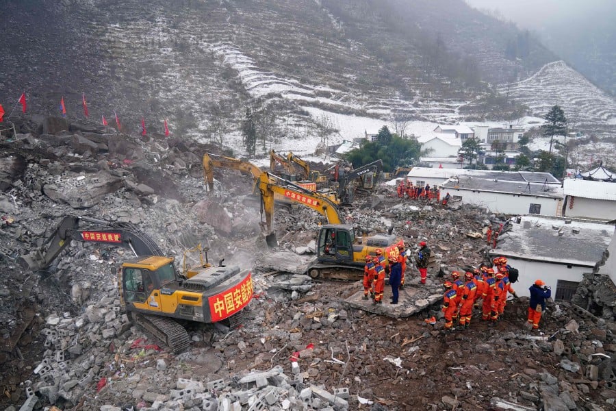 Rescue workers search for missing victims at a landslide site, a day after a landslide hits Liangshui village in Zhaotong, in southwestern China's Yunnan province. - AFP PIC