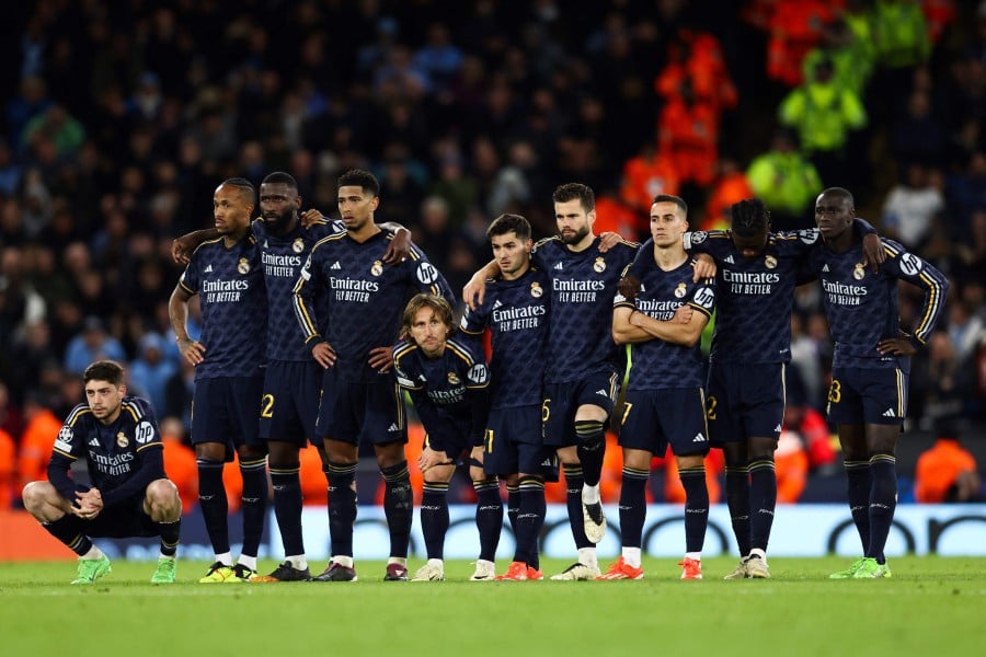 Real Madrid's players react during the penalty shootout during the UEFA Champions League quarter-final second-leg football match between Manchester City and Real Madrid, at the Etihad Stadium, in Manchester. - AFP PIC