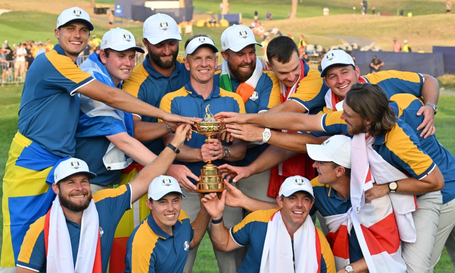  Europe's English captain, Luke Donald (C) poses with The Ryder Cup and his players after the presentation ceremony following the final day of play in the 44th Ryder Cup at the Marco Simone Golf and Country Club in Rome. - AFP PIC