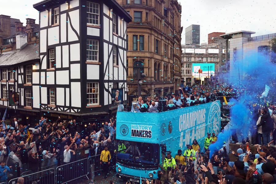 Manchester City's Erling Braut Haaland and Phil Foden with the Premier League trophy on the bus during the victory parade. REUTERS PIC