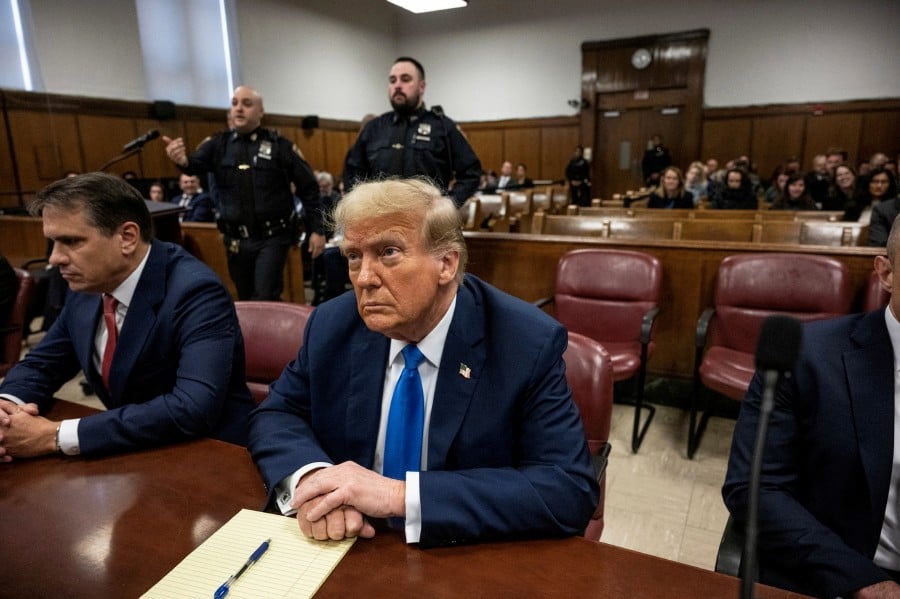 Former U.S. president and Republican presidential candidate Donald Trump sits in court on the first day of opening arguments in his trial at Manhattan Criminal Court for falsifying documents related to hush money payments, in New York. - REUTERS PIC