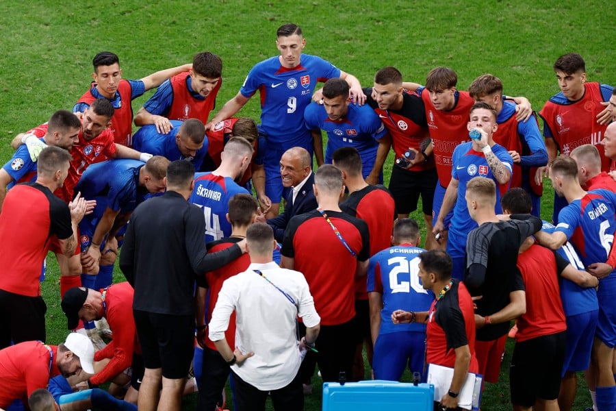 Slovakia's Italian head coach Francesco Calzona (C) speaks with his players before the first period of extra time during the UEFA Euro 2024 round of 16 football match between England and Slovakia at the Arena AufSchalke in Gelsenkirchen. - AFP PIC