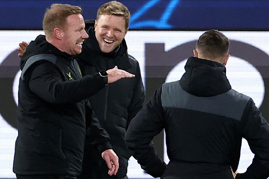 Newcastle's English coach Eddie Howe (C) jokes with members of the coaching staff during a training session at the Parc des Princes Stadium in Paris. - AFP PIC