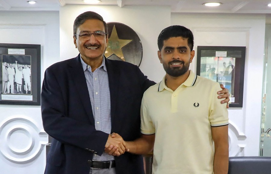 PCB Chairman Zaka Ashraf (L) shaking hands with Pakistan's cricket captain Babar Azam during a meeting at the PCB headquarters in Lahore. -AFP PIC