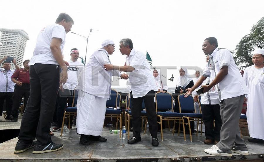  Umno president Datuk Seri Dr Ahmad Zahid Hamidi greets PAS president Datuk Seri Abdul Hadi Awang during the Anti-International Convention on the Elimination of All Forms of Racial Discrimination (ICERD) rally in Dataran Merdeka on Dec 8. - NSTP
