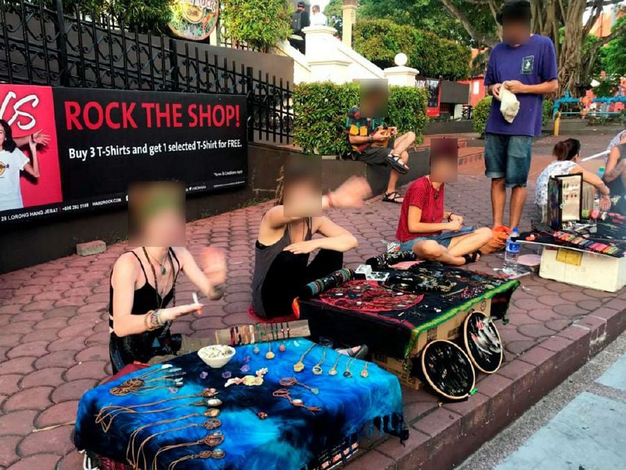 The tourists, mostly believed to be backpackers in their 20s, were said to be sitting on the sidewalk opposite the hotel premises and peddling the items illegally.Pic courtesy NST reader