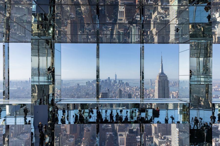 Attendees are reflected in mirrors at the Summit One Vanderbilt observation deck in New York.