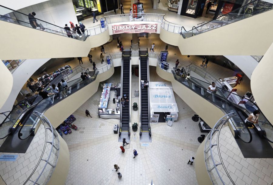 Shoppers walk through a mall. Bloomberg/Photo