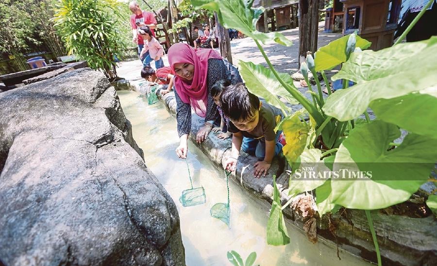 Catching fish, is one of the entertaining activities for kids at Farm In The City in Seri Kembangan, Selangor. PICTURE BY ROSELA ISMAIL