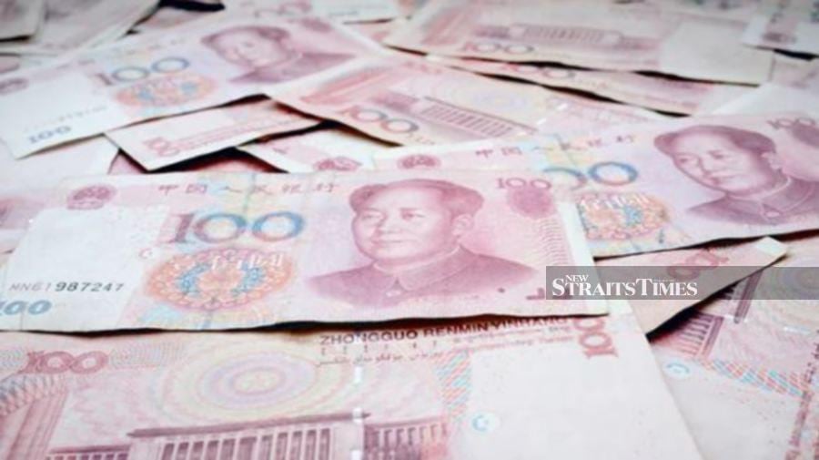 The yuan eased against the dollar on Wednesday after hawkish comments by a Federal Reserve official supported the greenback and on weaker guidance from China’s central bank.   