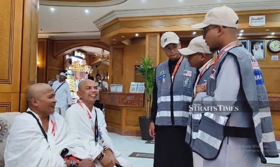Brothers Muhammad Adam Aiman Mohd Amizul Fazley, 21, Muhammad Edrish Ell-Fateh, 17, and 15-year-old Muhammad Nouh Ebdansyakur make it a point to help others and always appear cheerful, especially when dealing with elderly pilgrims.