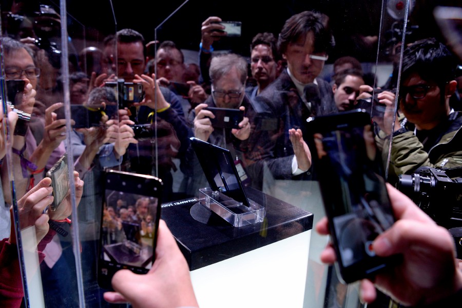 Visitors take images of Huawei's new foldable 5G smartphone HUAWEI Mate X at the Mobile World Congress (MWC), in Barcelona. - AFP