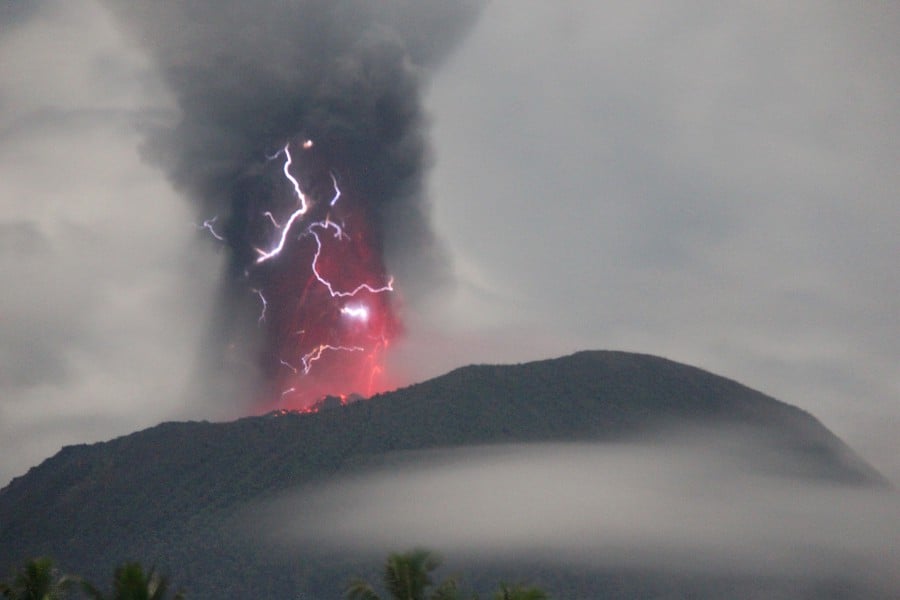 Lightning appears amid a storm as Gunung Ibu spews volcanic material during an eruption, as seen from Gam Ici in West Halmahera, North Maluku province, Indonesia. (The Center for Volcanology and Geological Hazard Mitigation (PVMBG)/Handout via REUTERS)