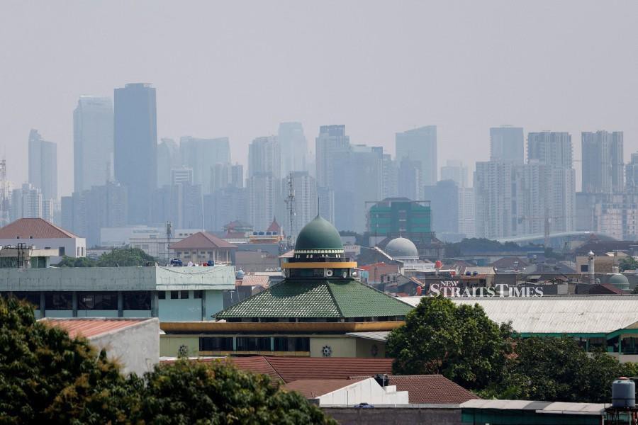 High-rise buildings in the background, in Jakarta. REUTERS/Willy Kurniawan/File Photo