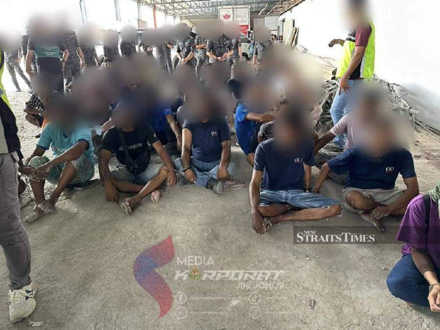  Johor immigration enforcement officers detained 159 undocumented foreigners working and residing in the country illegally in coordinated raids in hotspot areas. Pic courtesy of Johor Immigration Department. 