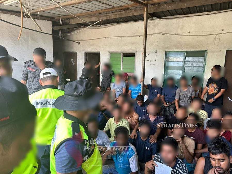  Johor immigration enforcement officers detained 159 undocumented foreigners working and residing in the country illegally in coordinated raids in hotspot areas. Pic courtesy of Johor Immigration Department. 