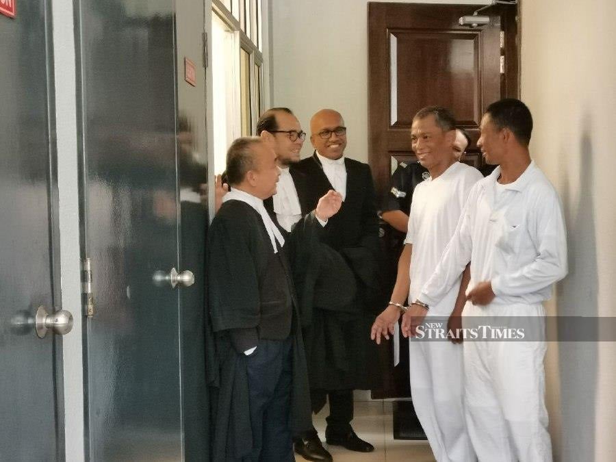  Maung Maung and Mg Aung Aung gesture after the hearing at the Seremban High Court. -NSTP/AHMAD HASBI.