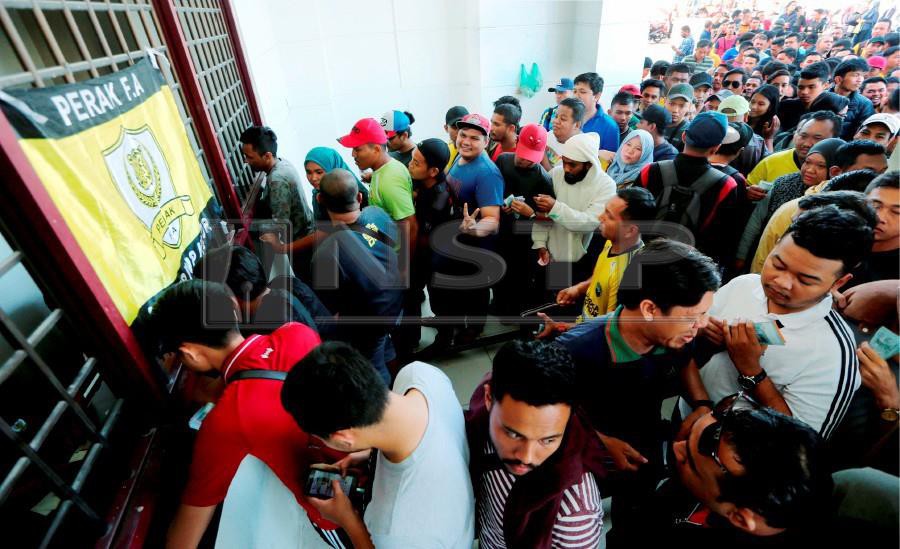 Perak fans lining up to purchase the tickets at the Perak Stadium in Ipoh. - NSTP/ABDULLAH YUSOF