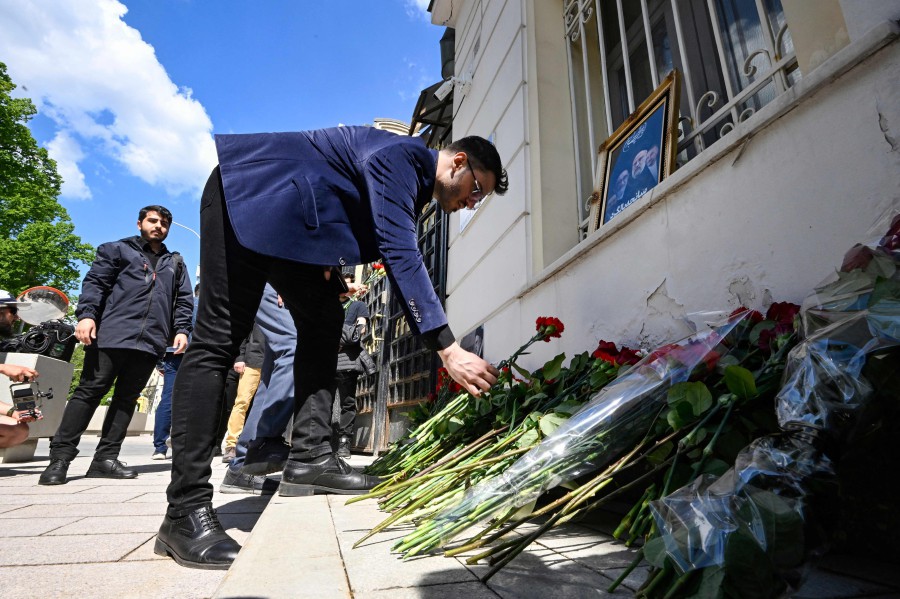 People bring flowers to the Iranian embassy to pay tribute to Iran's President Ebrahim Raisi and Foreign Minister Hossein Amir-Abdollahian, in Moscow. - AFP PIC