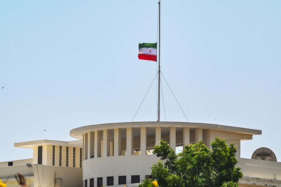 Iran's national flag flies at half mast atop the Iranian Consulate in Karachi. - AFP PIC