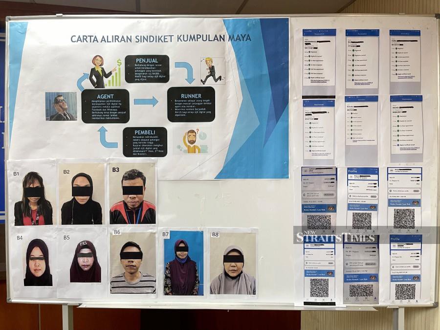 This January 19, 2022 pic shows the suspects arrested by police in connection with the sales of fake vaccination certificates in Johor Baru. This was revealed by Johor police chief Datuk Kamarul Zaman Mamat during a press conference at the Johor police contingent headquarters. - NSTP/NUR AISYAH MAZALAN