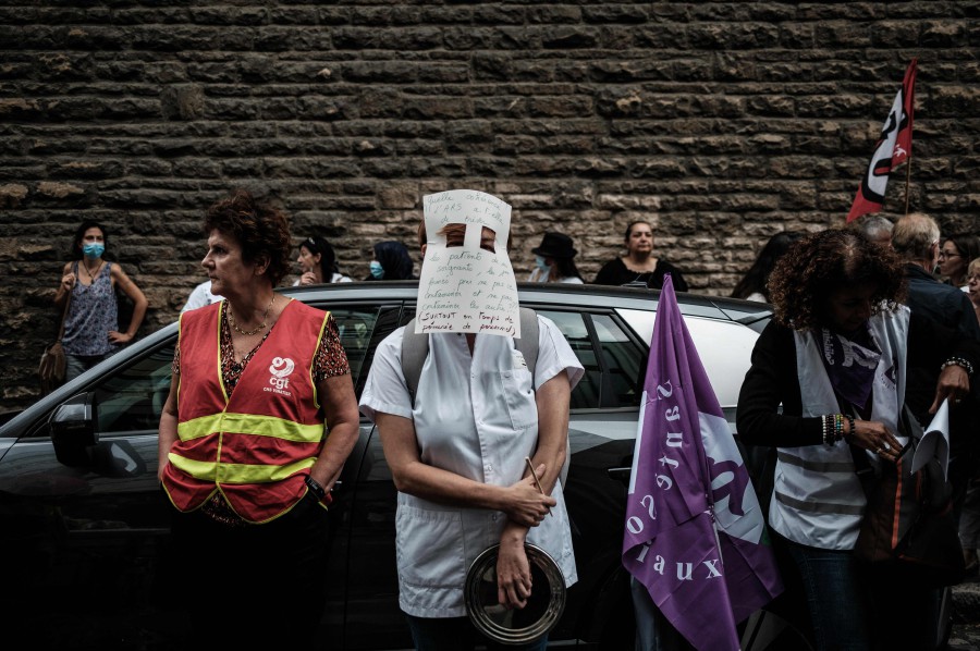 A nursing staff member wears a handmade mask during the demonstration in front of The A.R.S (regional Health agency) in Lyon, south-eastern France on September 14, 2021, against mandatory health passport 'pass sanitaire' obligation for hospital workers which the government is attempting to enforce to fight Covid-19. -AFP PIC