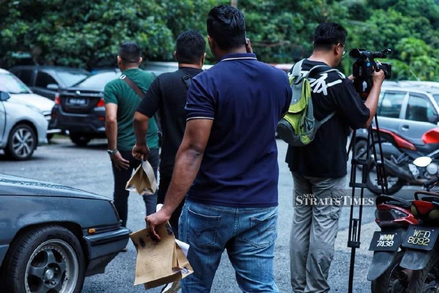Forensic officers seen carrying paper bags while leaving Zayn Rayyan Abdul Matiin’s home at Apartment Idaman, at Damansara Damai. -NSTP/ Nor Azizah Mokhtar