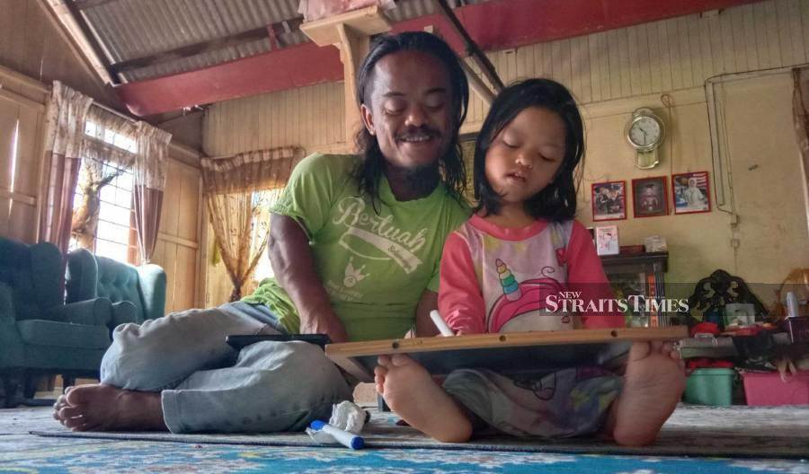 Mohd Afiq Fikri Firdaus Ibrahim with his daughter, Aufa. - NSTP/NAZDY HARUN