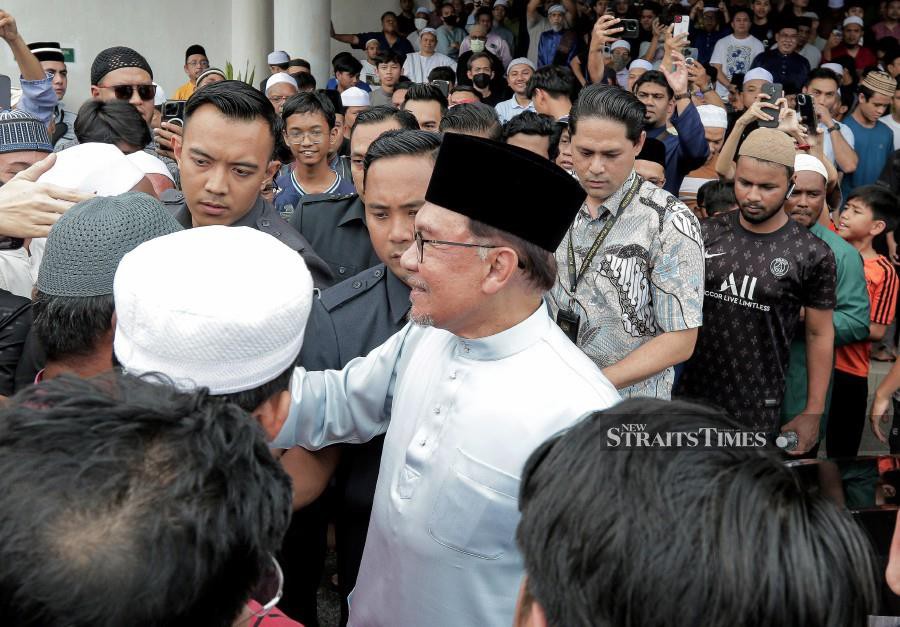Prime Minister Datuk Seri Anwar Ibrahim mingles with the congregation after performing Friday prayers at Kota Damansara Mosque. -NSTP/SADIQ SANI