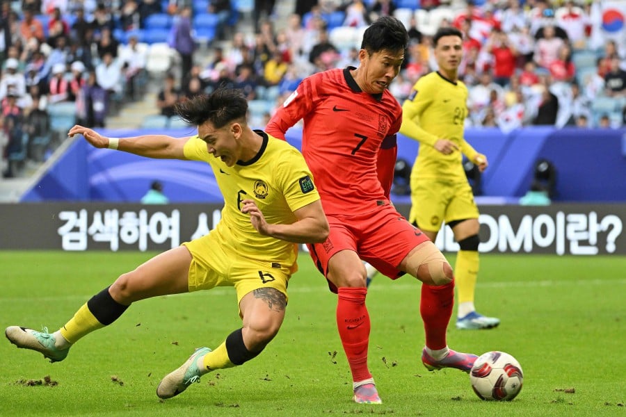 South Korea's midfielder #07 Son Heung-min runs with the ball past Malaysia's defender #06 Dominic Tan during the Qatar 2023 AFC Asian Cup Group E football match between South Korea and Malaysia on January 25, 2024. - AFP pic