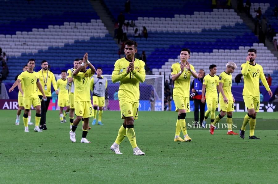 Malaysian players applaud their fans after the match against Jordan in Doha. -NSTP/HAIRUL ANUAR RAHIM