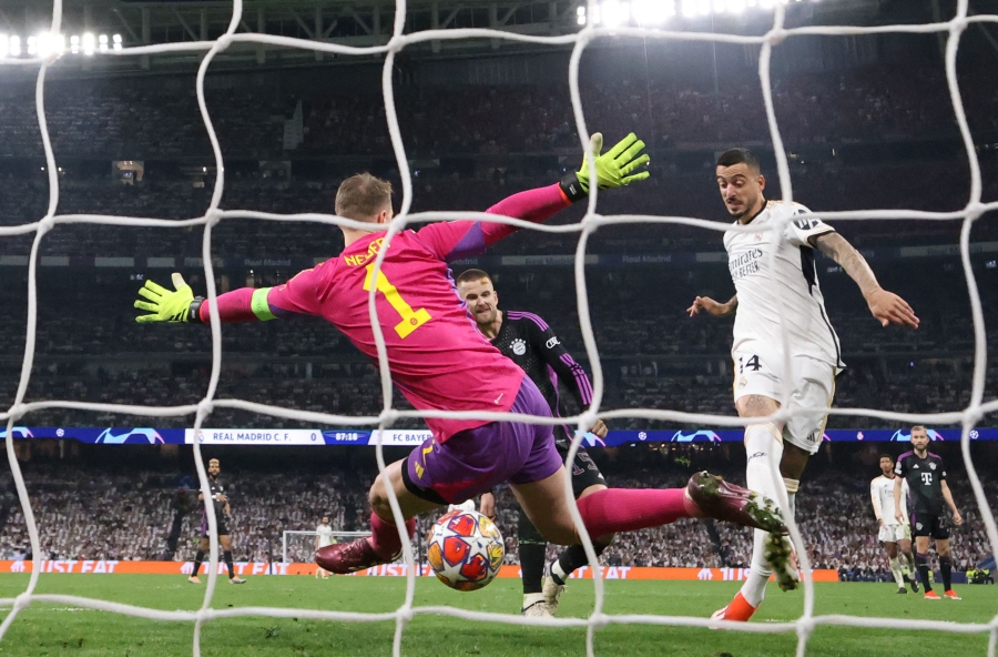 Real Madrid’s Joselu (right) scores past Bayern Munich goalkeeper Manuel Neuer during Wednesday’s Champions League semi-final second leg match at the Santiago Bernabeu Stadium in Madrid. - AFP PIC