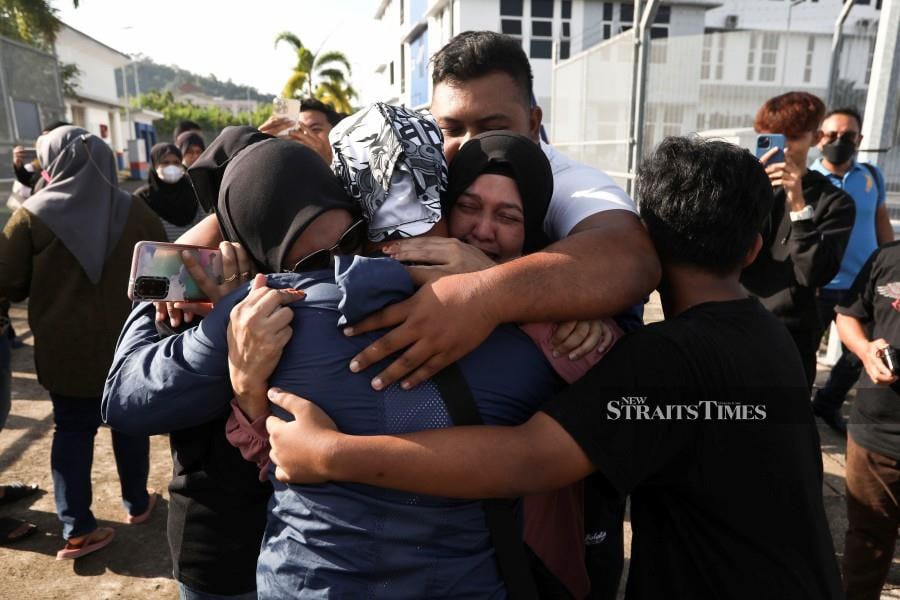 One of the rescued angler is welcomed by his family members at  the MMEA jetty in Kuala Terengganu. - NSTP/GHAZALI KORI