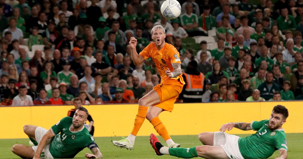 Denzel Dumfries (R) from the Netherlands disputes a ball with