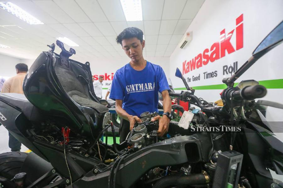 A trainee at the centre works on a Kawasaki motorcycle. NSTP/WAN NABIL NASIR